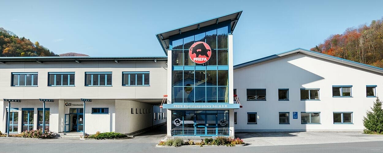 PREFA company building with white façade and blue windows