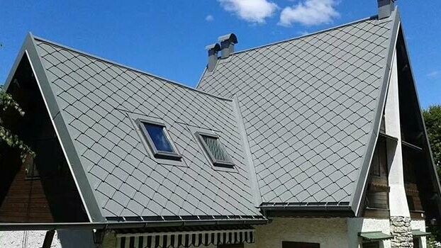 Steep gable roof clad with PREFA rhomboid roof tiles.
