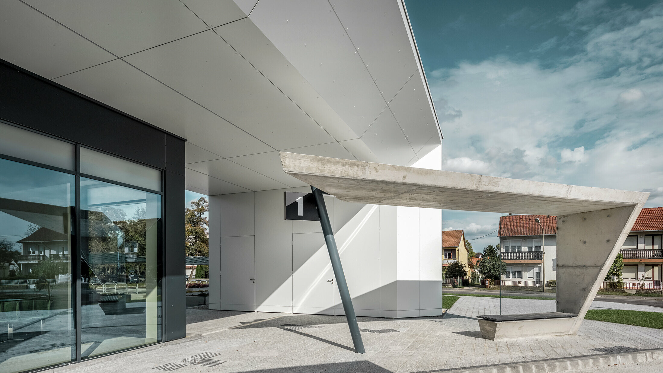 The new railway station in Lenti. The picture shows the bus stop number one. PREFABONd aluminium composite panels in the colour P.10 anthracite and pure white was used on the showed façade.