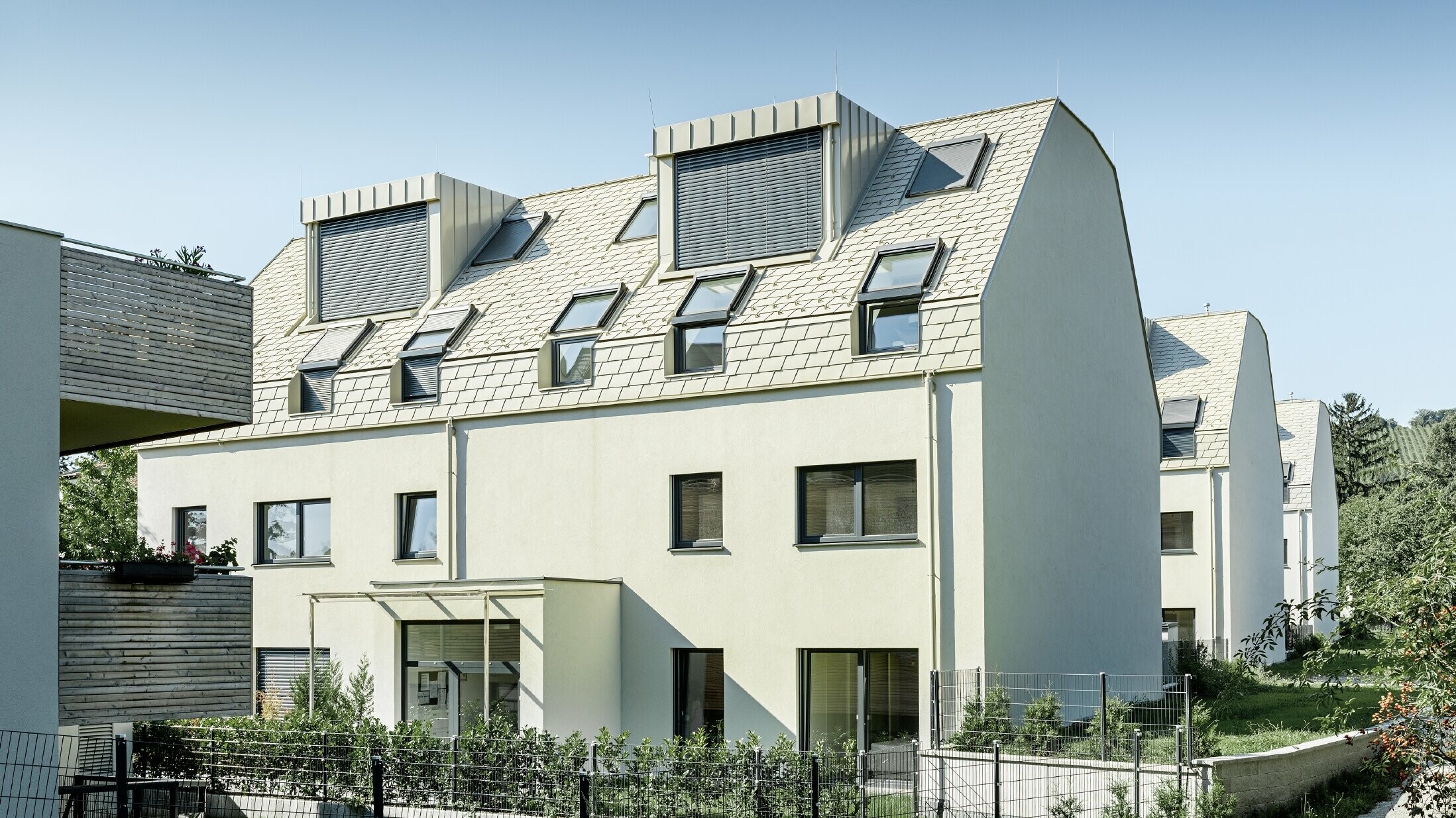 New residential complex with a large aluminium roof surface and a host of roof windows