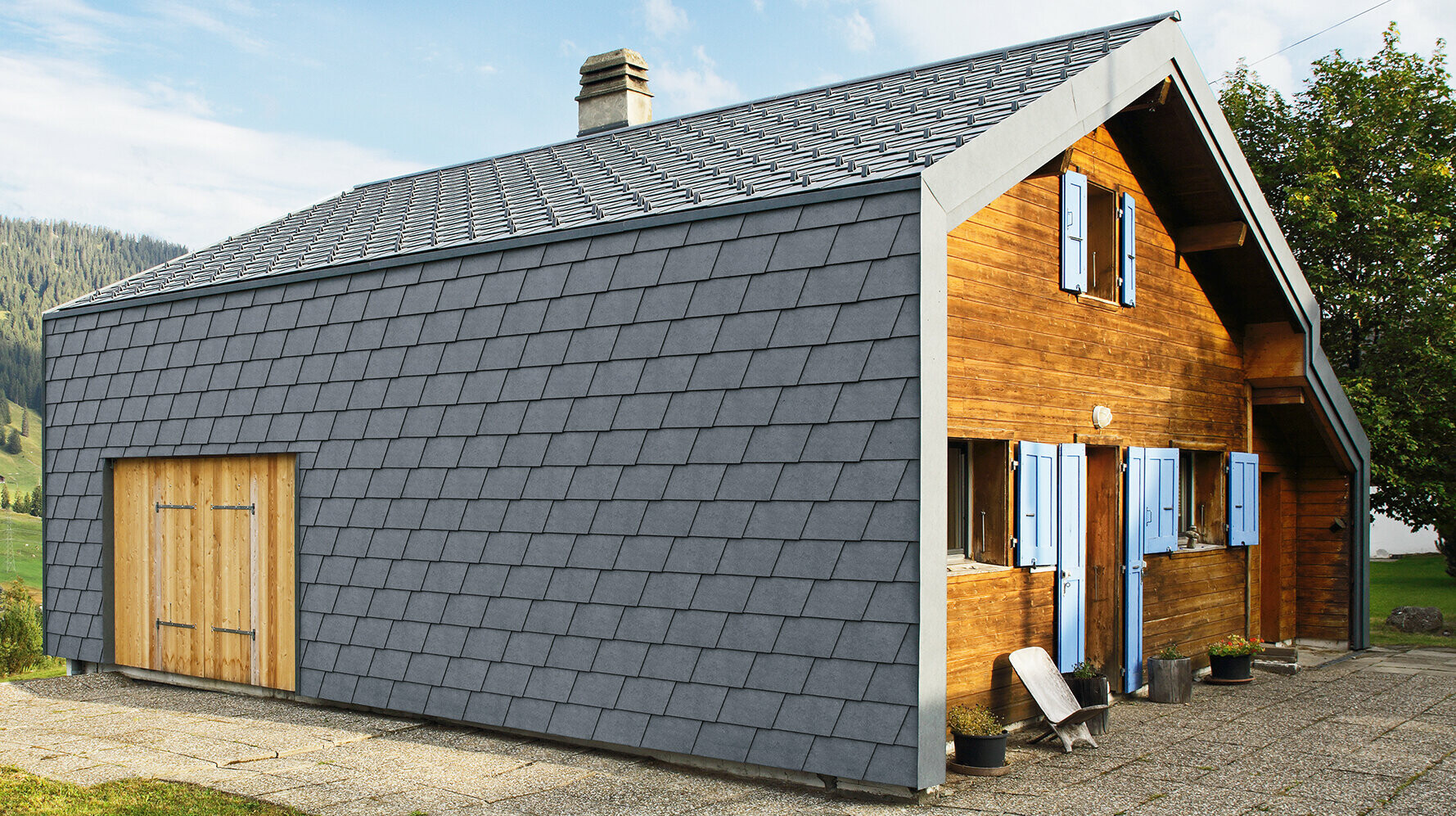 Modern detached house clad with PREFA façade shingles in anthracite and wooden elements.