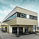 Modern extension with workshop and office of Guggisberg Dachtechnik with PREFA aluminium composite panels in bronze